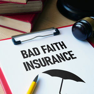 Clipboard labeled 'Bad Faith Insurance' with a gavel, pen, and law books in the background